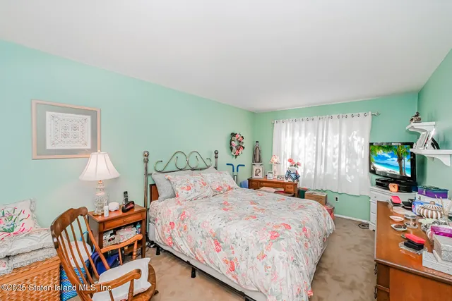 a bedroom with a bed and a tv in it