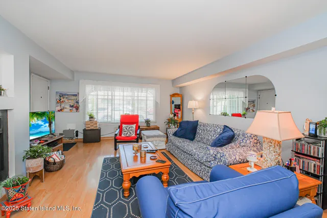 a living room with furniture fireplace and a window