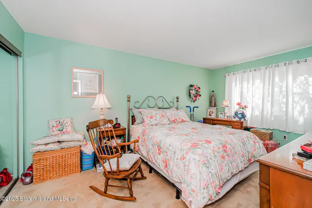 a bedroom with a bed a table and chair