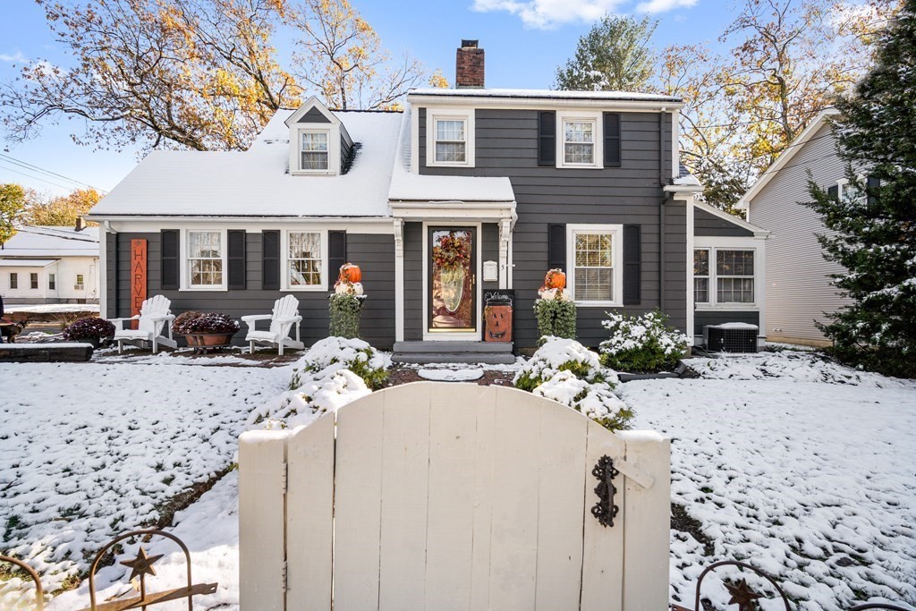 a view of a house with a yard covered in snow