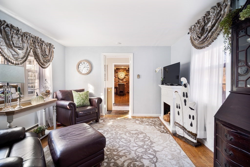 5 Mayfield Street Springfield, MA 01108 - Photo 17 of 30 a living room with furniture a flat screen tv and a wall painting