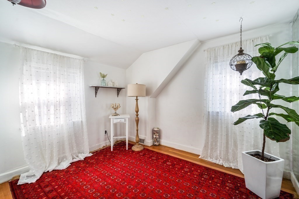 5 Mayfield Street Springfield, MA 01108 - Photo 21 of 30 a bedroom with a bed and a potted plant