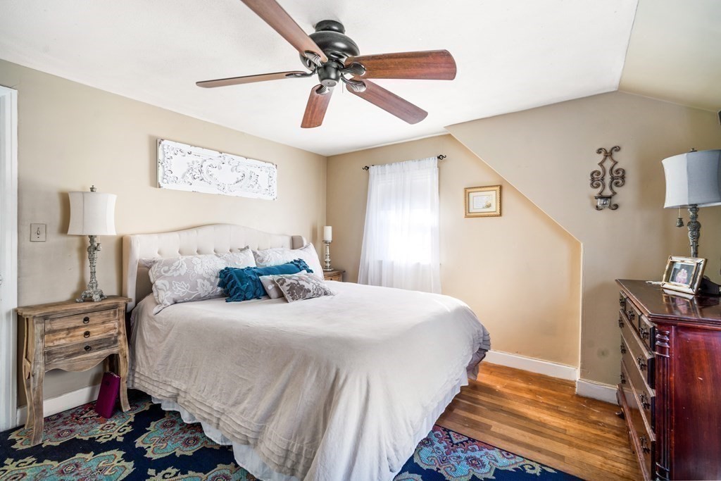 5 Mayfield Street Springfield, MA 01108 - Photo 23 of 30 a bedroom with a bed and a chandelier