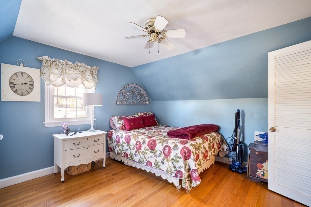 5 Mayfield Street Springfield, MA 01108 - Photo 25 of 30 a bedroom with a bed and a chandelier