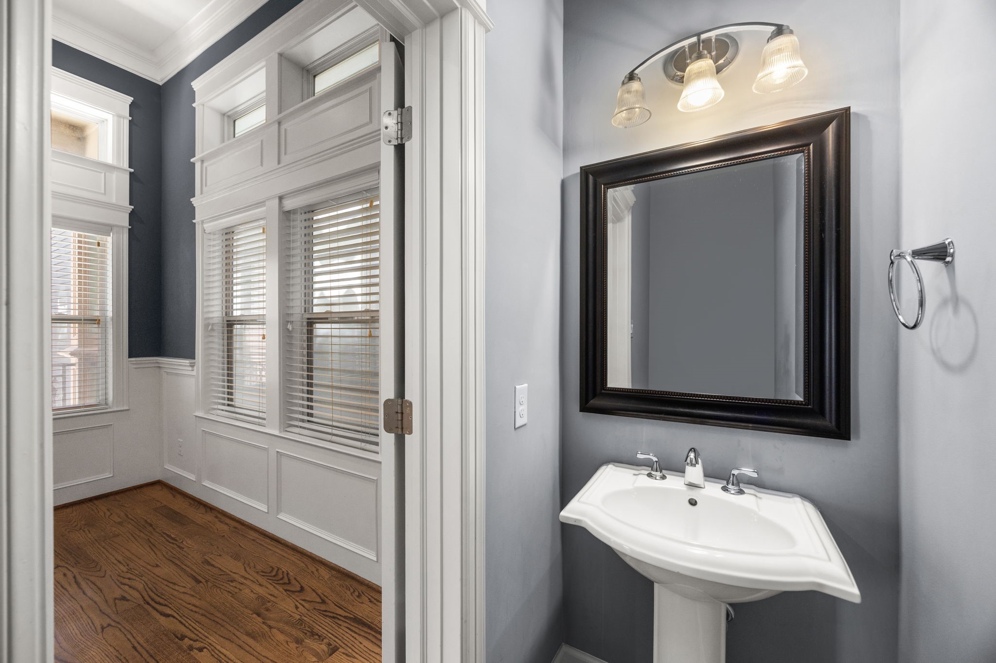 619 Rutland Street, Unit B Houston, TX 77007 - Photo 9 of 33 a bathroom with a sink a mirror and wooden floor