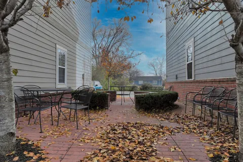 a backyard of a house with table and chairs