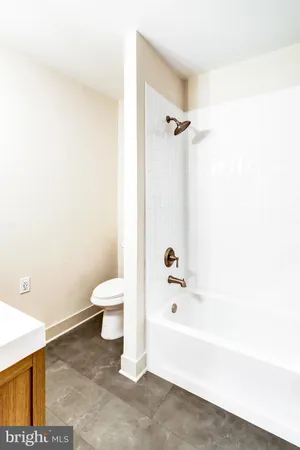 a bathroom with a bathtub and toilet