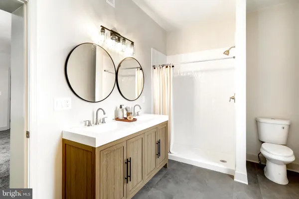 a bathroom with a sink a toilet and a mirror