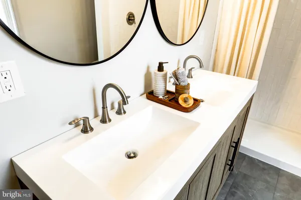a bathroom with a sink a mirror and a window