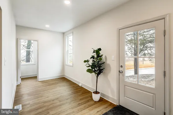 a view of entryway with window and wooden floor