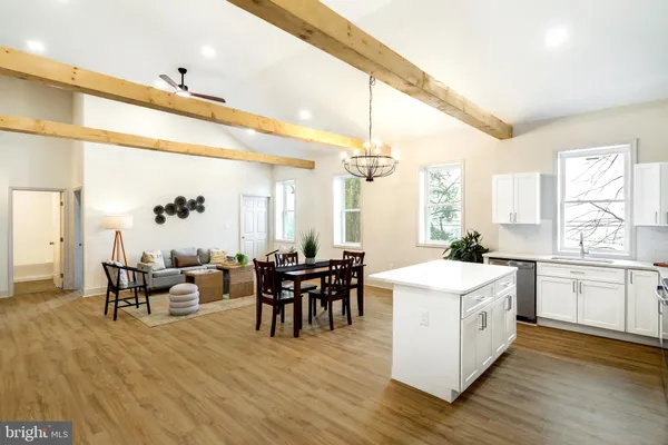 a large white kitchen with a large window