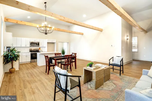 a view of a dining room with furniture and wooden floor
