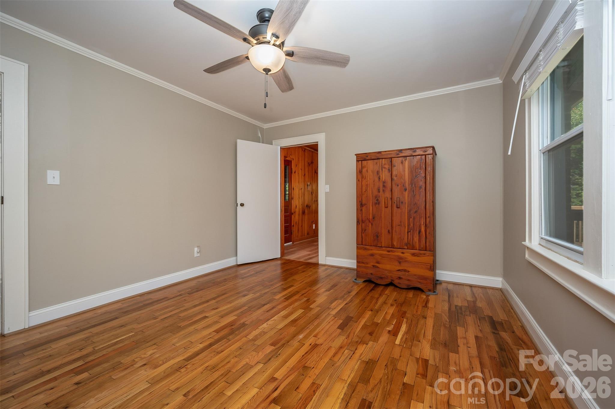 351 Waters Road Bostic, NC 28018 - Photo 12 of 35 a view of an empty room with wooden floor and a window