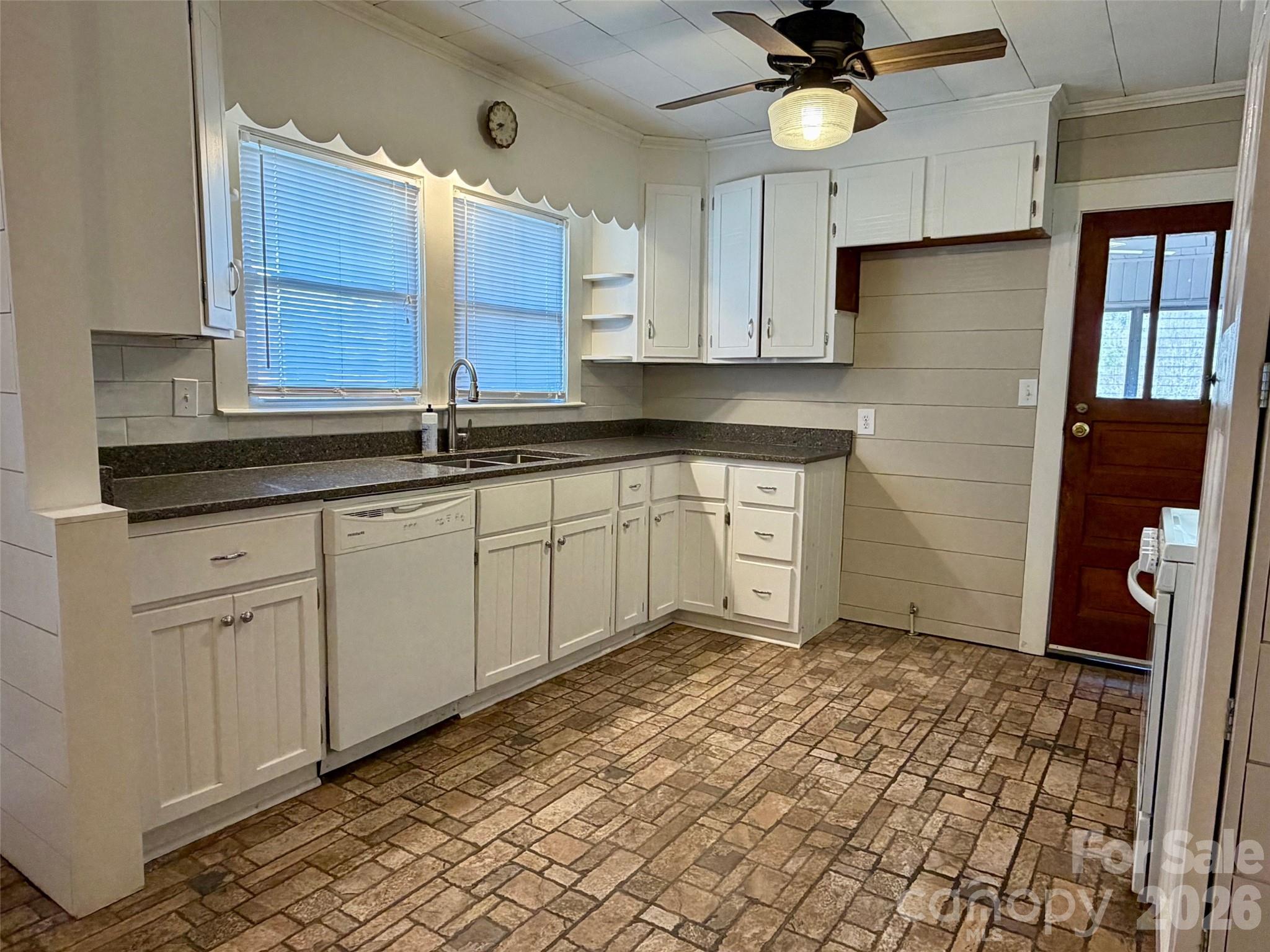 351 Waters Road Bostic, NC 28018 - Photo 10 of 35 a kitchen with granite countertop a sink a window stainless steel appliances and cabinets