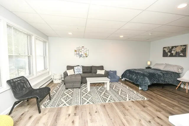 a bedroom with furniture and a large window