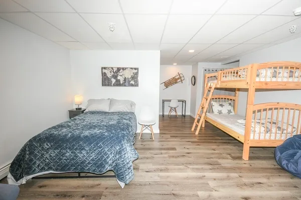 a bedroom with a bed and a large window