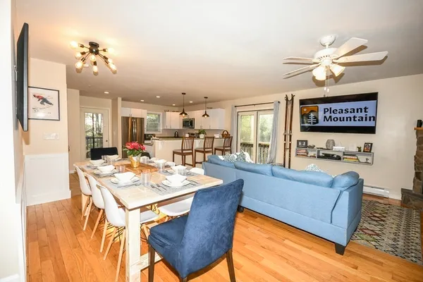 a living room with kitchen island furniture and a chandelier