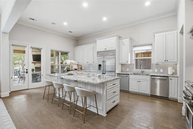 a kitchen with stainless steel appliances granite countertop a stove oven and a refrigerator
