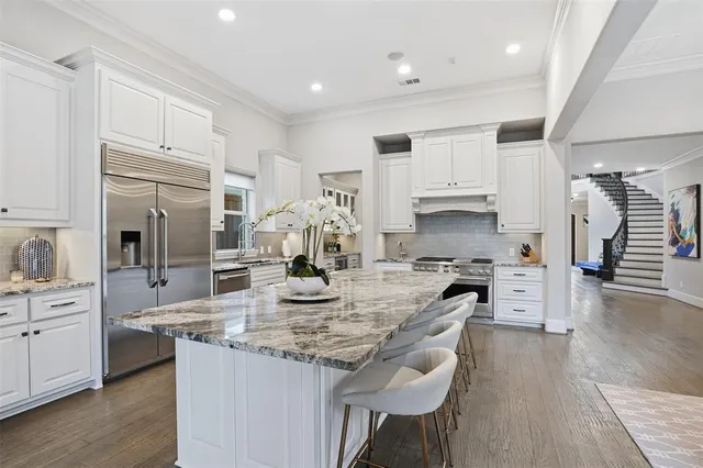 a kitchen with stainless steel appliances granite countertop a sink stove and refrigerator