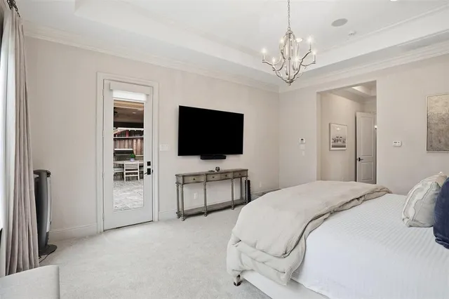 a spacious bedroom with a bed and a flat screen tv