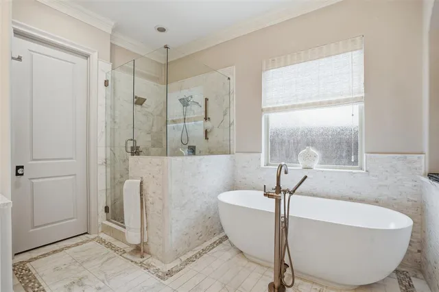 a bath tub sitting in a bathroom next to a window