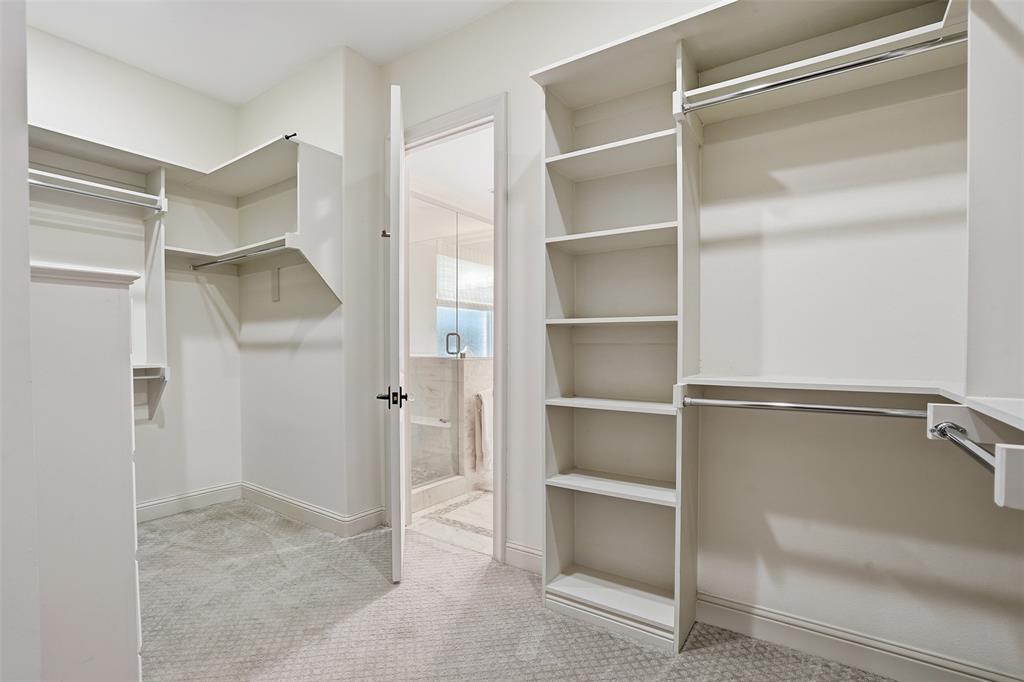 6714 Williamson Road Dallas, TX 75214 - Photo 22 of 40 a view of an empty walk in closet and a bathroom
