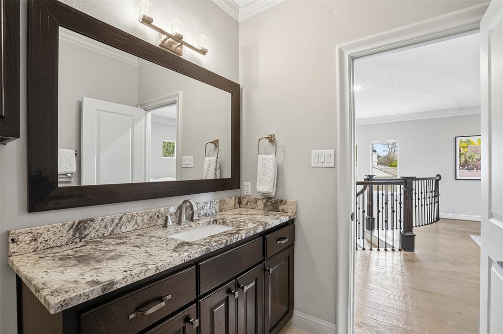 6714 Williamson Road Dallas, TX 75214 - Photo 27 of 40 a bathroom with a granite countertop sink and a mirror