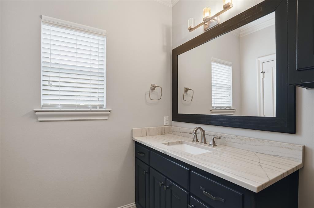 6714 Williamson Road Dallas, TX 75214 - Photo 29 of 40 a bathroom with a granite countertop sink and a mirror
