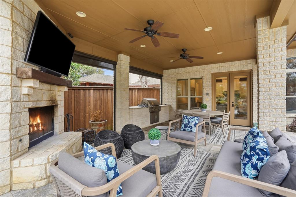 6714 Williamson Road Dallas, TX 75214 - Photo 32 of 40 a living room with furniture a fireplace and a flat screen tv