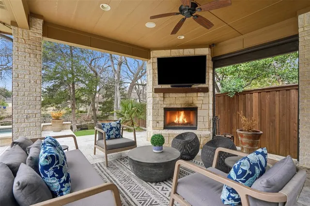a living room with furniture fireplace and a large window