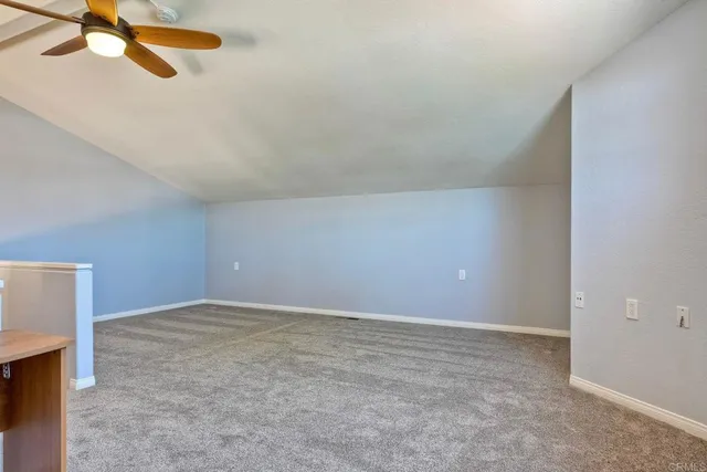 a bathroom with a granite countertop double vanity sink and a mirror