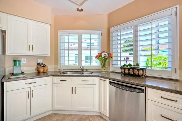 a living room with fireplace furniture and a large window