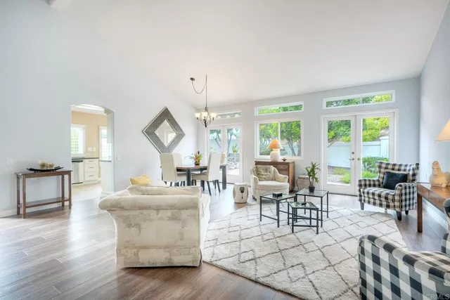 a bathroom with a sink a mirror and a potted plant