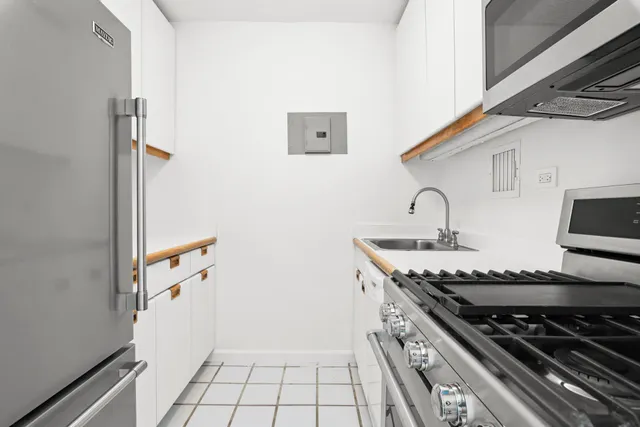 a kitchen with stainless steel appliances granite countertop a stove and a sink