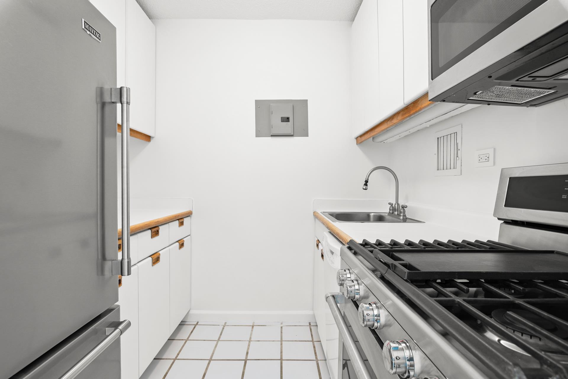 a kitchen with stainless steel appliances granite countertop a stove and a sink