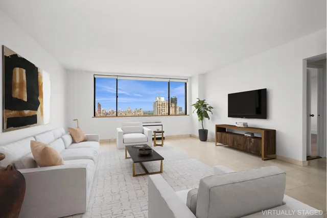 a living room with furniture a flat screen tv and a window