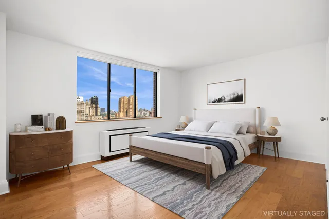 a spacious bedroom with a bed and cabinets