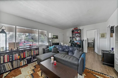 a living room with furniture a rug and a book shelf