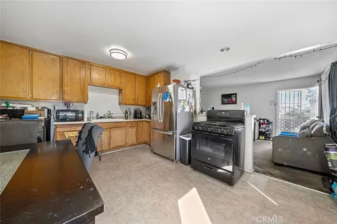 a kitchen with a refrigerator and a stove