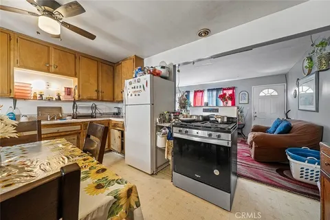 a kitchen with stainless steel appliances granite countertop a stove and a refrigerator
