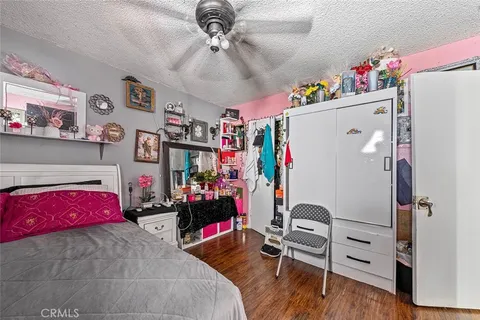 a bedroom with furniture and a flat screen tv