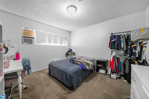a bed room with a bed and a desk