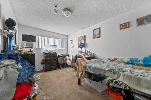 a bedroom with bed and a large window