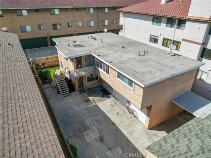 a view of a balcony with a barbeque and wooden floor