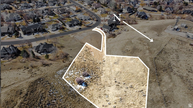 Aerial view of property and surrounding area with property boundaries highlighted and nearby suburban area