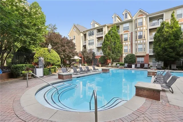a view of a swimming pool with outdoor seating