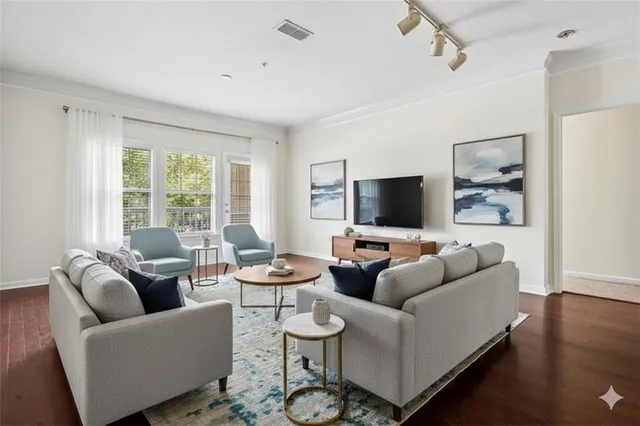 a living room with furniture and a flat screen tv