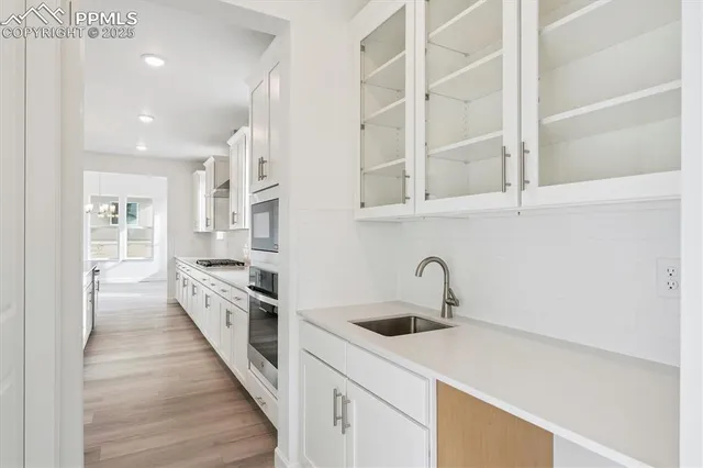 a kitchen with granite countertop a sink and cabinets