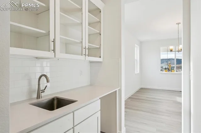 an empty room with windows and fireplace
