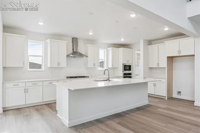 a kitchen with a stove sink and a refrigerator